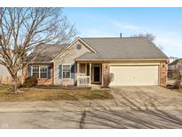 Charming home featuring blue shutters, brick accents, a well-manicured lawn, and an attached two-car garage at 11168 Autumn Harvest Dr, Fishers, IN 46038