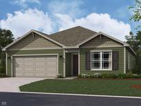 Charming single-story home featuring a two-car garage, well-manicured lawn, and traditional architectural design elements at 1704 N Winthrop Rd, Muncie, IN 47304