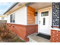 Charming front door with decorative welcome sign, brick accents, and fresh paint at 2847 Merts Dr, Indianapolis, IN 46237