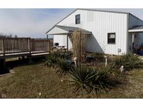 Charming two-story white home featuring a covered porch and a beautifully landscaped front yard at 3060 N Alaska Rd, Cloverdale, IN 46120