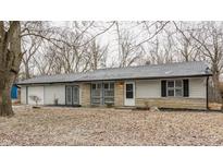 Charming single-story home with stone accents, attached garage, and leafless trees in the front yard at 3137 N Richardt Ave, Indianapolis, IN 46226
