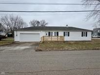 Charming single-story home featuring white siding, black shutters, and an attached garage at 3154 S Holt Rd, Indianapolis, IN 46221