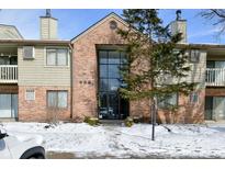 Two-story brick building with a modern glass entrance and landscaping in a snow covered lawn at 4281 Village Parkway W Cir # 8, Indianapolis, IN 46254
