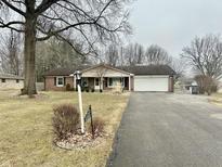 Charming brick home with a well-manicured front yard and an attached two-car garage at 4315 E Brunswick Ave, Indianapolis, IN 46237
