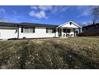 Charming single-story home with white brick, black trim, and a inviting front porch at 4424 Greenhill Way, Anderson, IN 46012