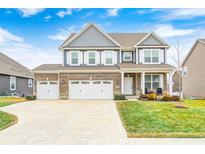 Beautiful two-story brick home with a three-car garage and well-manicured lawn at 4862 Brickert Way, Greenwood, IN 46142