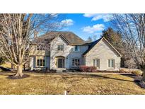 Charming two-story brick home with a well-manicured lawn and mature trees, reflecting classic suburban elegance at 4906 Willow Ridge Ct, Zionsville, IN 46077
