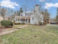 Charming cottage-style home with a welcoming front porch and well-maintained lawn at 6143 Riverview Dr, Indianapolis, IN 46208