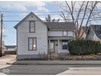 Charming two-story home featuring a cozy porch and classic architectural details at 615 W 10Th St, Indianapolis, IN 46202