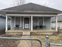 Charming home featuring a cozy front porch for relaxing and entertaining outdoors at 712 Lynn St, Indianapolis, IN 46222