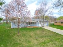 Charming single-story home featuring a well-maintained lawn, covered front porch, and attached garage at 7610 Brehob Rd, Indianapolis, IN 46217