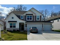 Charming two-story home featuring a three-car garage and a well-manicured lawn at 8623 Lester Pl, Pendleton, IN 46064