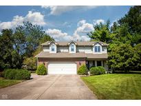 Charming two-story home with a well-manicured front yard and attached two-car garage at 8845 Lesley Ln, Brownsburg, IN 46112