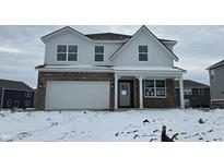 Charming two-story home with a brick facade and a spacious two-car garage, perfect for modern living at 1209 Taggart Way, Greenwood, IN 46143