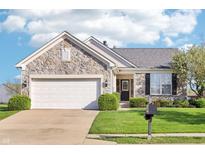 Charming single-Gathering home with stone facade, attached two-car garage, and well-manicured lawn at 12880 Oxbridge Pl, Fishers, IN 46037