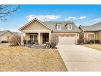 Charming home featuring a blend of stone and siding, dormer windows and a covered front porch at 163 Bridgemor Ln, Mooresville, IN 46158