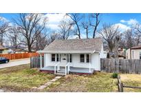Cozy home boasts a quaint front porch, fresh paint, and inviting curb appeal at 2173 N Drexel Ave, Indianapolis, IN 46218