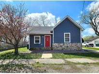 Charming blue home with stone accents, bright red door, and a well-maintained front yard under a sunny blue sky at 422 Johnson Ave, Franklin, IN 46131