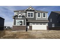 New construction two-story home with gray siding, brick base, white trim, and two-car garage at 4364 Pine Bluff Dr, Bargersville, IN 46106
