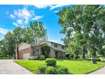 Beautifully landscaped two-story home with a brick facade, attached garage, and verdant lawn at 502 Ironwood Dr, Carmel, IN 46033