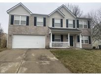 Two story home with a two car garage and front porch at 5801 Safari Dr, Indianapolis, IN 46237