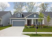 Charming single-story home features a well-manicured lawn, attached garage, and inviting front porch at 7188 Covington St, Lebanon, IN 46052