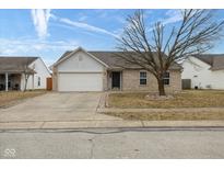 Charming single-story home featuring a two-car garage and a well-manicured front yard on a sunny day at 8091 Crumwell Dr, Avon, IN 46123
