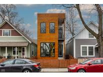Modern home with wood siding, black windows, and fence, with a small balcony at 924 Prospect St, Indianapolis, IN 46203