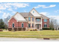 Beautiful two-story brick home with a stone facade and second story balcony at 1032 Westview Point Dr, Columbus, IN 47201