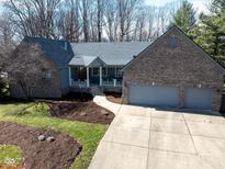 Charming brick home with a well-manicured lawn and a spacious two-car garage at 1086 Pebble Brook Dr, Noblesville, IN 46062