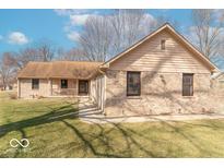 Charming single-story home featuring a brick facade, covered porch, and well-maintained lawn at 12064 N Glena Pl, Mooresville, IN 46168