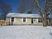 Charming single-story home with snow-covered yard and welcoming front door at 12504 S Hillview Rd, Columbus, IN 47201