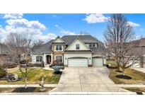 Traditional home featuring a well-manicured front lawn and a three-car garage at 19311 Morrison Way, Noblesville, IN 46060