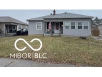 Charming single-story home featuring a well-maintained lawn, cozy front porch, and traditional siding at 233 N 16Th Ave, Beech Grove, IN 46107