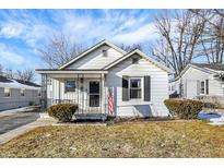 Charming bungalow-style home with white siding, black shutters, and a cozy front porch at 26 Highland Ave, Franklin, IN 46131