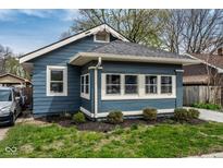 Charming bungalow featuring a blue exterior, well-maintained landscaping and a number over the front window at 3708 Rockville Rd, Indianapolis, IN 46222