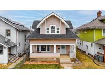 Charming two-story home featuring a welcoming front porch and classic architectural details at 49 N Tremont St, Indianapolis, IN 46222