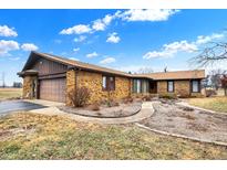 Beautiful stone facade home with a two-car garage and well-maintained front yard on a sunny day at 5272 N Graham Rd, Whiteland, IN 46184