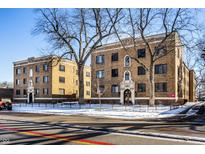 Classic brick apartment building with manicured landscaping and a secure gated entrance at 5347 N College Ave # 311, Indianapolis, IN 46220