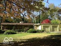 Charming one-story home featuring a two-car garage and mature landscaping at 5506 N Drexel Ave, Indianapolis, IN 46220
