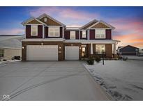Two-story brick and siding home with a three car garage and a large concrete driveway at 6281 Burgin Dr, Whitestown, IN 46075