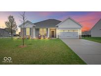 Charming single-Gathering home featuring a manicured lawn and two-car garage with stone and siding at 6848 Kara Ln, Brownsburg, IN 46112