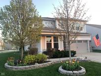 Charming two-story home featuring stone accents, a two-car garage, and a beautifully landscaped front yard at 6861 Park Grove Blvd, Whitestown, IN 46075