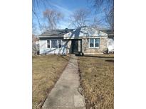 Charming single-story house featuring stone accents and a well-maintained front yard at 732 W 12Th St, Indianapolis, IN 46202