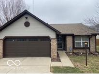 Charming home featuring brick accents and a well-maintained two-car garage at 7816 Harcourt Springs Ct, Indianapolis, IN 46260