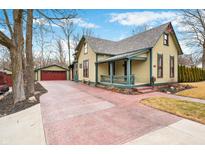 Charming home showcasing an attached garage and a wide, brick-paved driveway at 800 E King St, Franklin, IN 46131