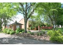 Brick building at the end of a driveway with lots of trees at 8501 Canterbury E Sq, Indianapolis, IN 46260