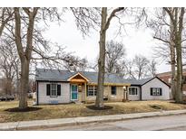 Charming single-story home with stone accents, a welcoming porch, and a well-maintained front yard at 1002 E 36Th St, Indianapolis, IN 46205