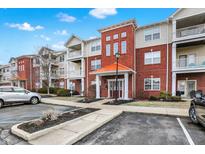 Inviting brick condominium with manicured landscaping, covered entry, and ample parking at 17223 Gunther Blvd # 310, Westfield, IN 46074