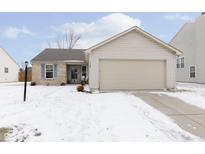 Charming single-story home with a two-car garage and a well-maintained front yard on a partly cloudy day at 17339 Pine Wood Ln, Westfield, IN 46074